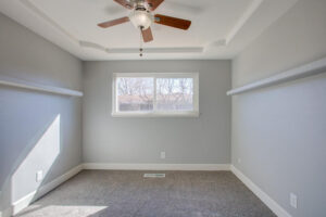 room with brown ceiling fan and gray walls